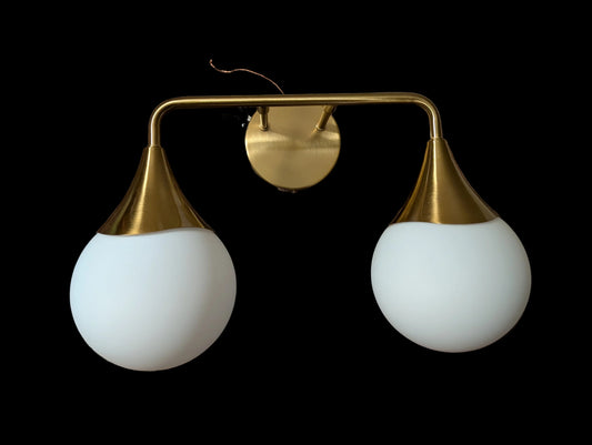 Gold wall sconce with white glass shades